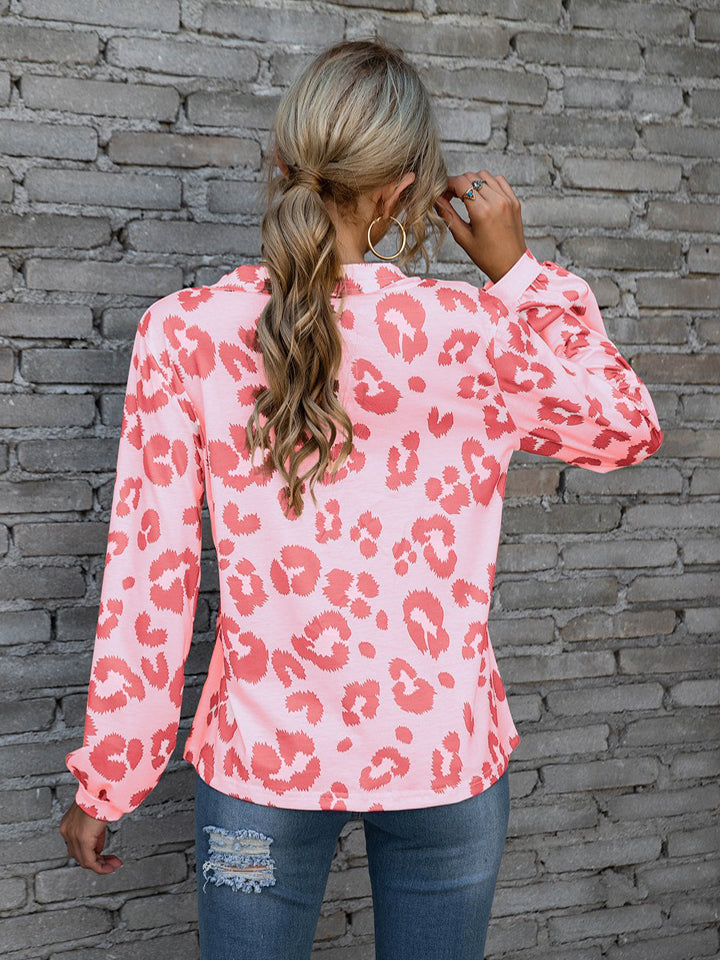 Pink leopard print blouse with blouson sleeves and button neckline