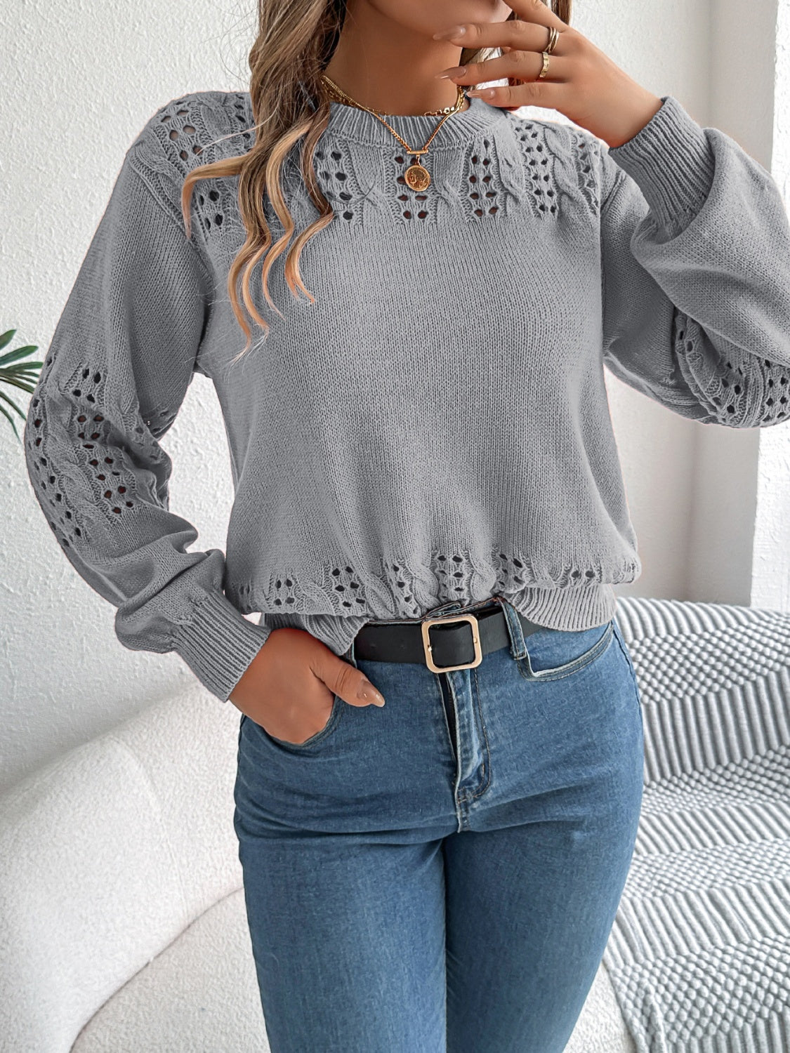 Gray acrylic knit sweater with openwork detail on sleeves and neckline.