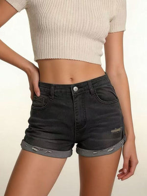 Black distressed denim roll-up shorts with button fly and cuffed hems.