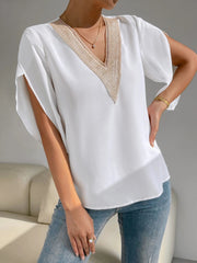 White blouse with lace trim V-neck and cape sleeves