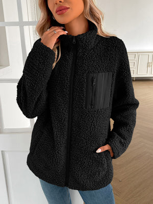 Black teddy fleece jacket with zip front, mock neck, and zippered chest pocket.