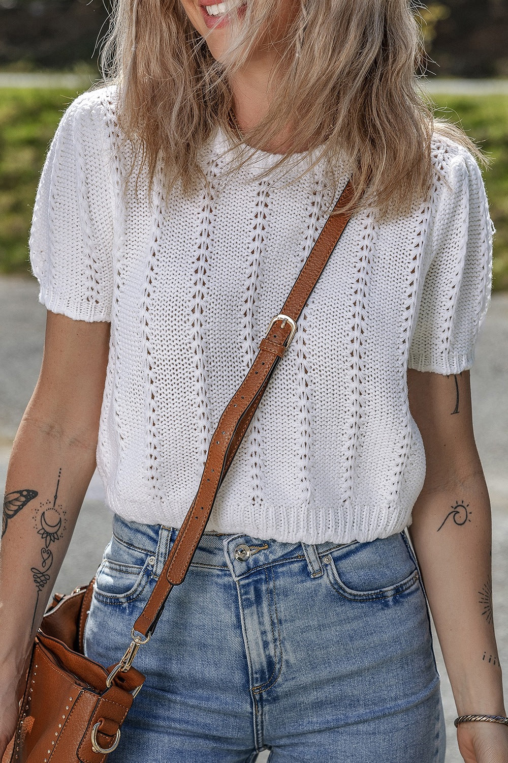 White eyelet knit puff sleeve top with vertical stitch detail.