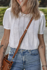 White eyelet knit puff sleeve top with vertical stitch detail.