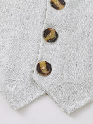 Baby vest with tortoise shell buttons and subtle texture