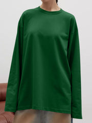 Oversized crewneck sweatshirt in dark green with voluminous long sleeves.