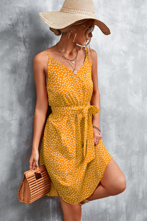 Mustard daisy print slip dress with tie waist and V-neck.
