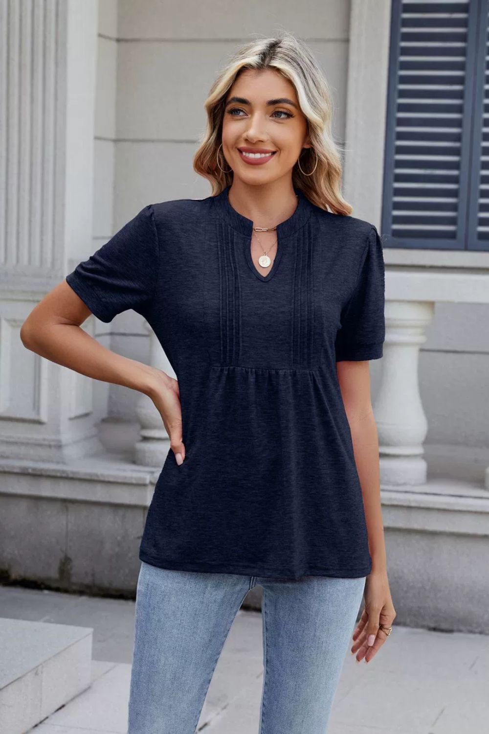 Dark navy pleated yoke henley tee with short sleeves and a keyhole neckline.