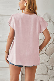 Lilac textured V-neck blouse with flutter sleeves and a relaxed fit.