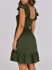 Army green smocked mini dress with ruffle trim and flutter sleeves.