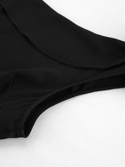 Black asymmetrical mini dress with a draped detail and scoop neckline.