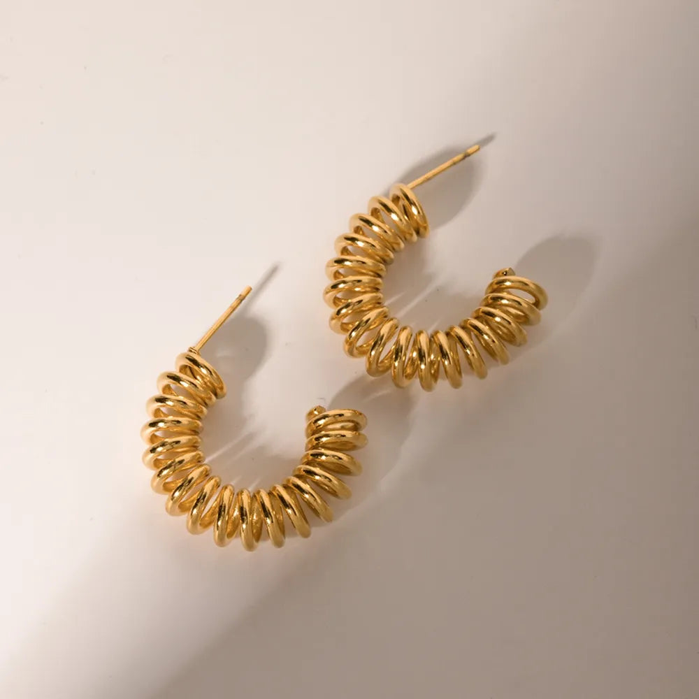 Gold vermeil spiral coil hoop earrings with a coiled design.