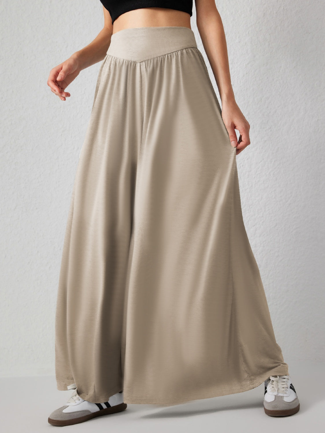 Khaki jersey wide-leg trousers with drape-front detail and elastic waistband.