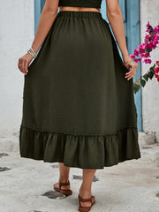 Tiered midi skirt in dark green with textured fabric and ruffled hem.