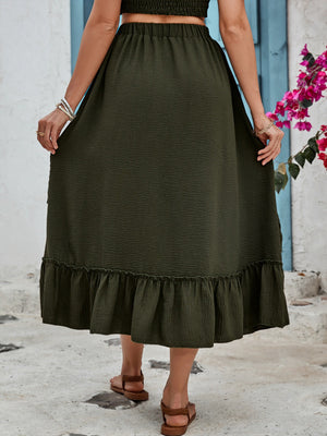 Tiered midi skirt in dark green with textured fabric and ruffled hem.