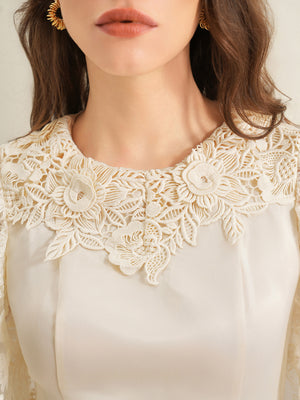 Apricot lace trimmed short-sleeve blouse with floral neckline detail.