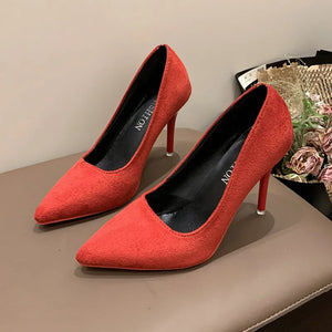 Red suede pointed stiletto pumps with crimson soles and black insoles.