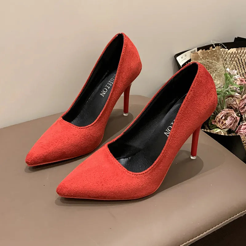 Red suede pointed stiletto pumps with crimson soles and black insoles.