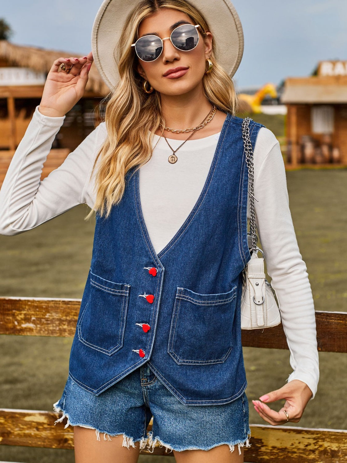 Indigo denim vest with red heart buttons and chest pockets
