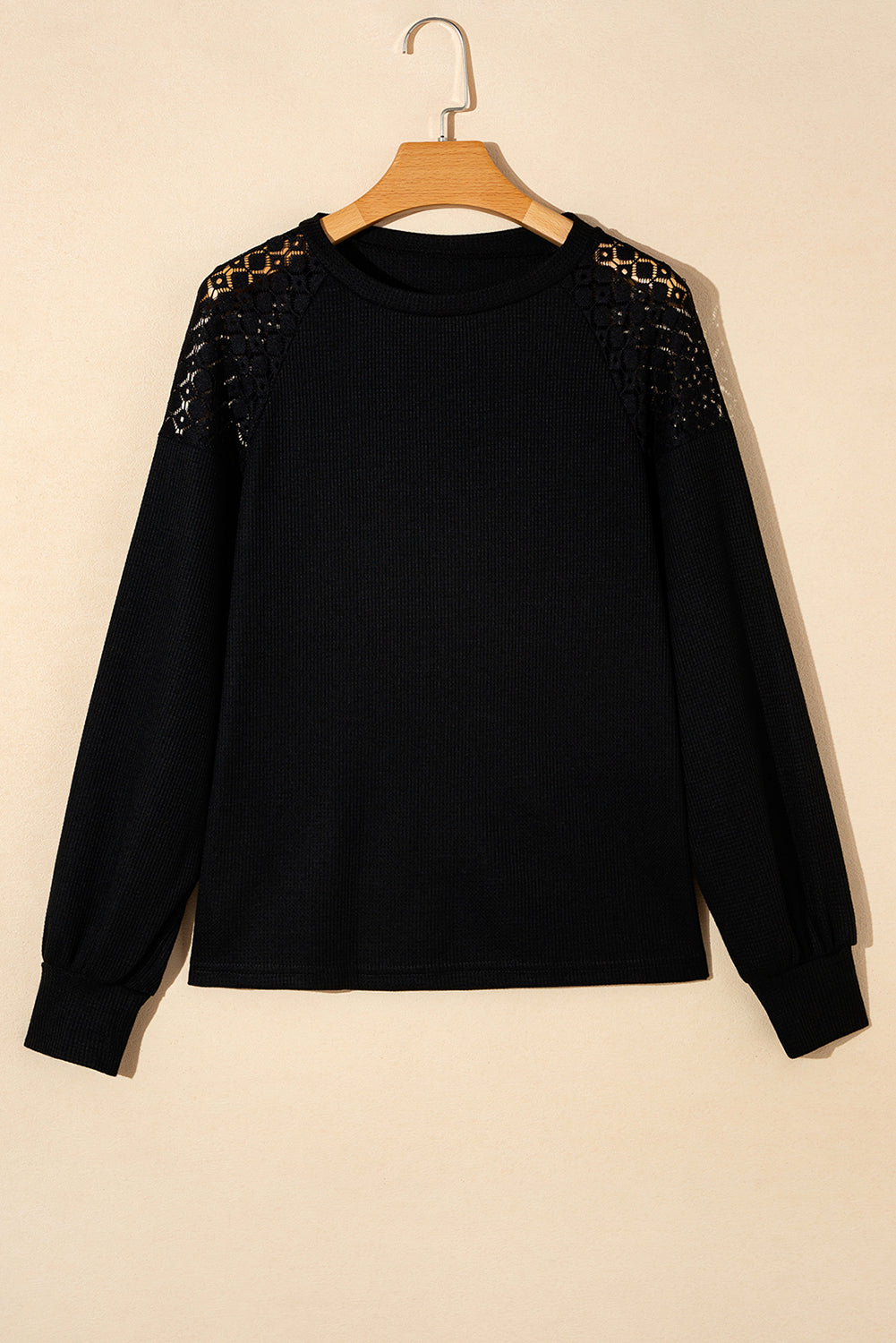 Black waffle knit raglan top with lace yoke detail and long sleeves.