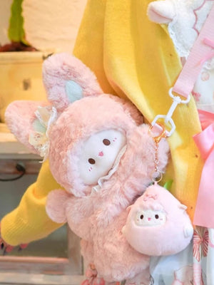 Pink plush bunny backpack with lace trim and a matching sheep charm.
