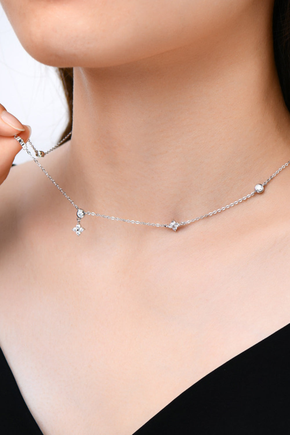 Silver diamond cluster necklace with scattered cubic zirconia accents.