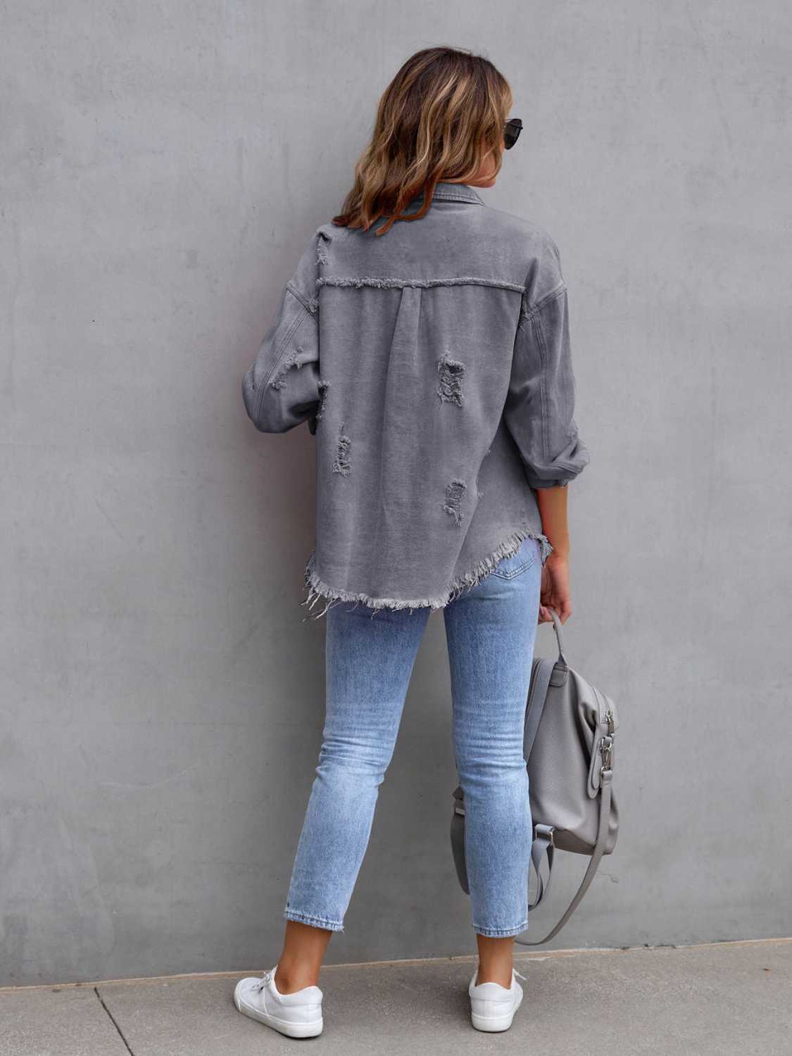 Gray distressed denim shacket with frayed hem and cuffs, worn with light wash jeans.