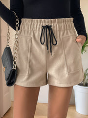 Tan paperbag waist utility shorts with drawstring and patch pockets.