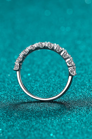 Silver moissanite eternity band ring with a row of brilliant stones.