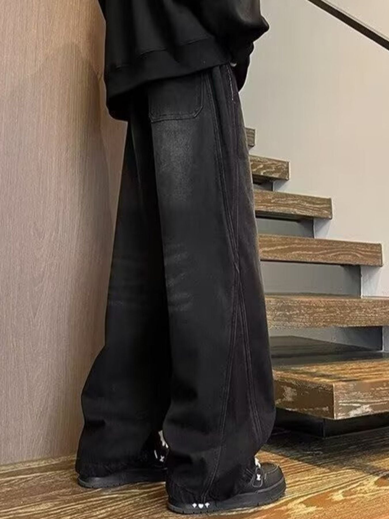 Men's black wide leg jeans with drawstring waist and casual fit.