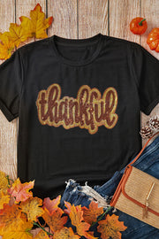 Black cotton tee with sequin "thankful" appliqué, crew neck, short sleeves.