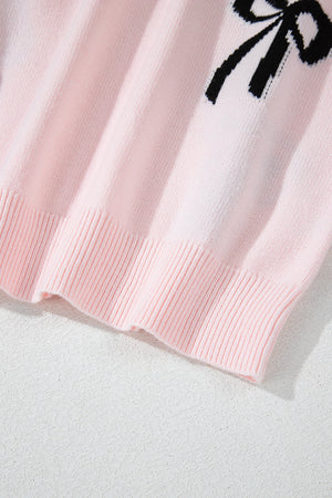 Blush pink knit crewneck sweater with black bow motif detail and ribbed hem.