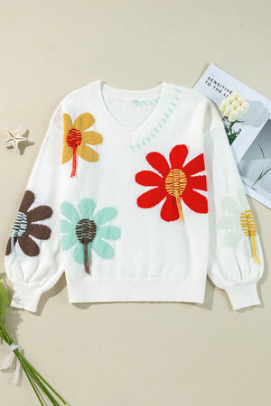 White knit sweater with embroidered floral pattern, V-neck, and balloon sleeves.