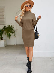 Caramel ribbed knit midi dress with dolman sleeves and a turtleneck, styled with a hat and boots.