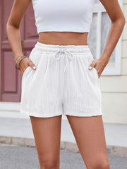 White textured wave drawstring shorts with pockets and elastic waistband