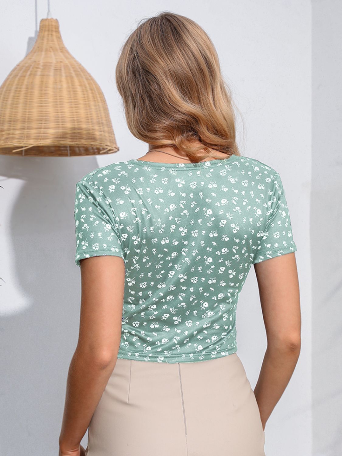 Light green floral print crossover crop top with short sleeves.
