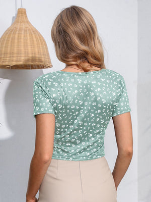Light green floral print crossover crop top with short sleeves.