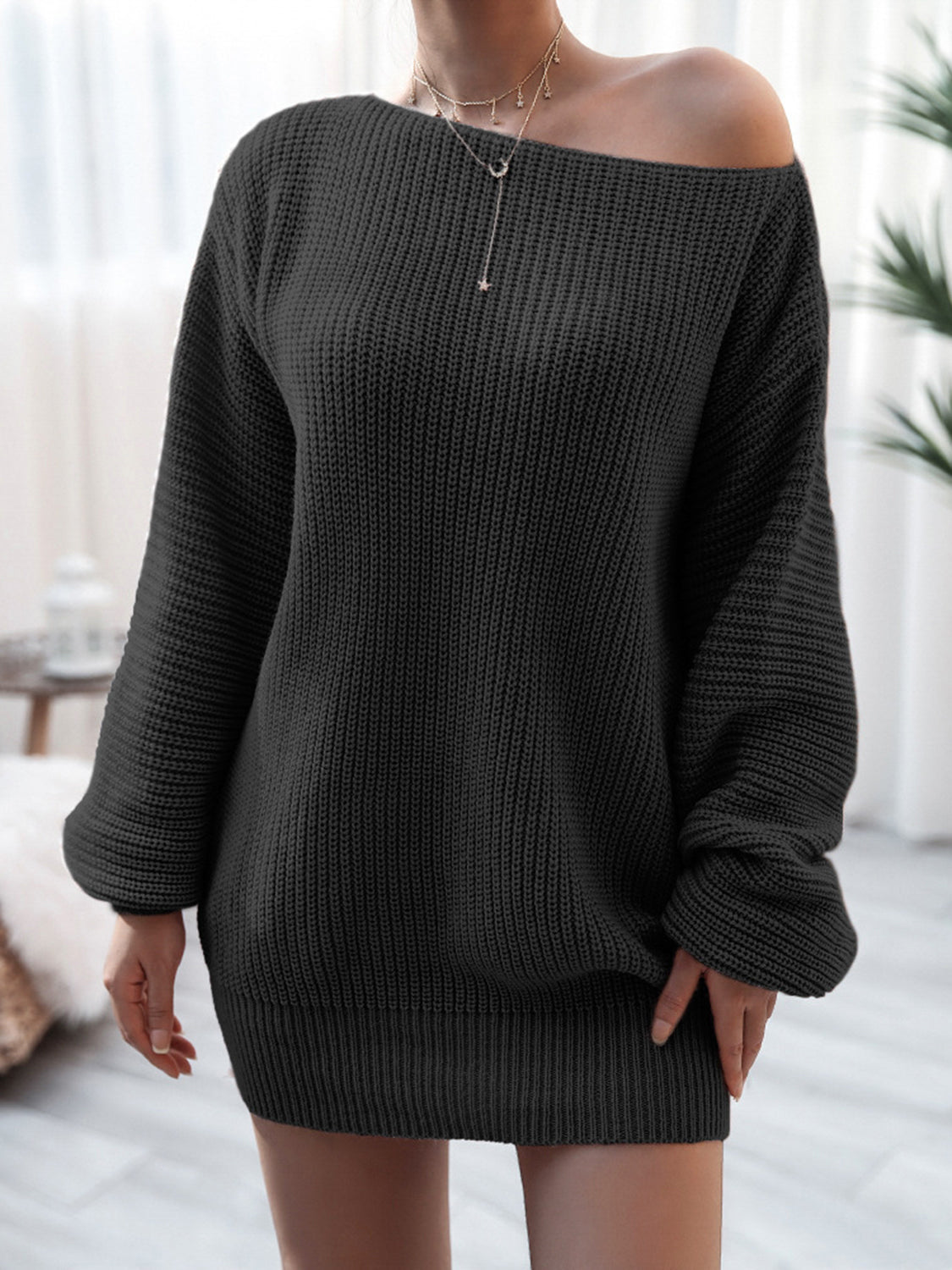 Black off-shoulder ribbed knit mini dress with long sleeves.