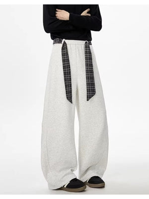 Light gray relaxed fit wide-leg sweatpants with plaid drawstring detail.