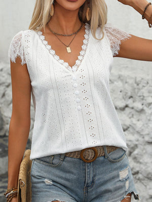 White eyelet lace trim button-down blouse with v-neck and short sleeves.