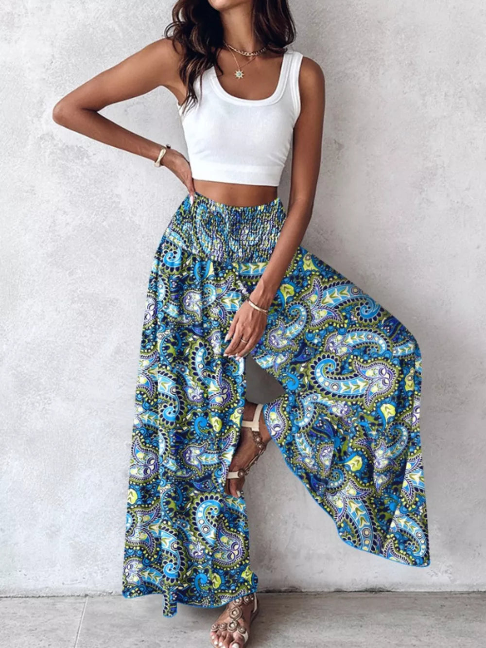 Bohemian print wide-leg pants with smocked waist in blue and green paisley pattern.