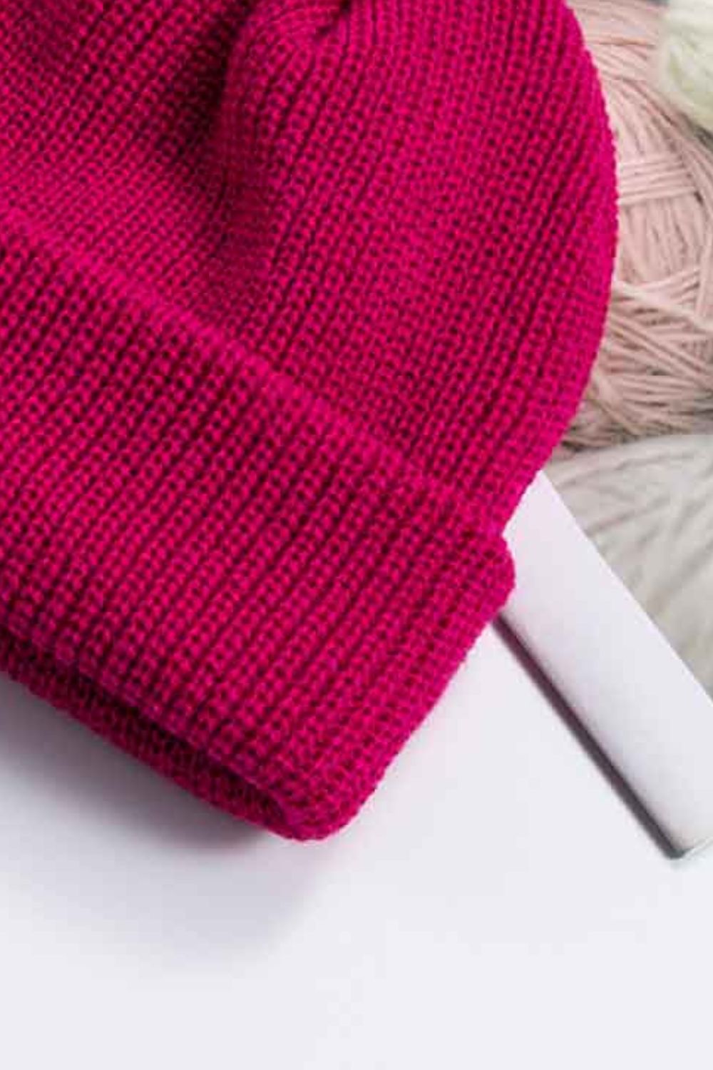 Ribbed knit beanie in magenta with a turn-up cuff.