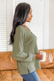 Waffle knit henley pullover in Matcha Green with button detail and side slits.