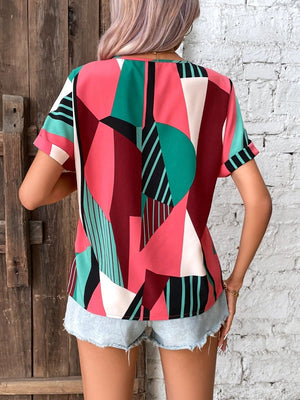 Geometric print V-neck blouse with short sleeves in multicolor.