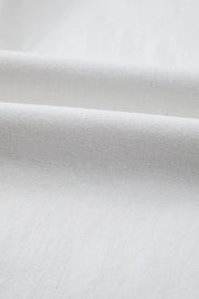 White cotton denim fabric detail of high-waisted straight leg jeans