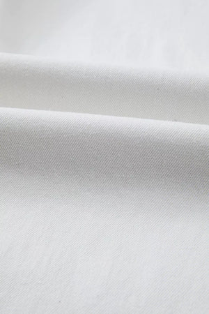 White cotton denim fabric detail of high-waisted straight leg jeans