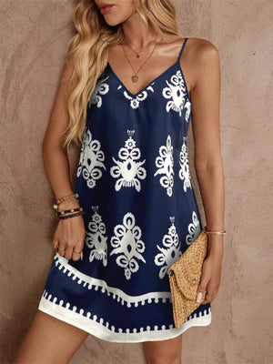 Navy V-neck mini dress with white bohemian print and tiered hem.