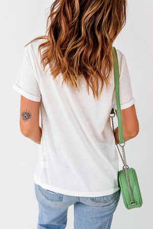 White casual t-shirt with rolled sleeves and an eye tattoo on the arm.