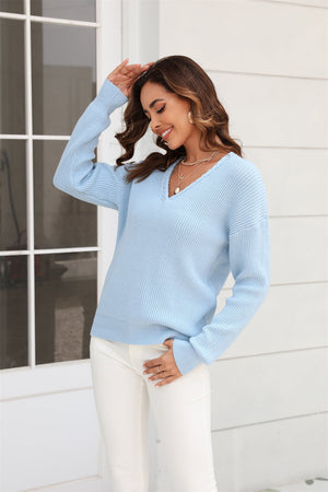 Light blue ribbed knit v-neck sweater with long sleeves and a relaxed fit.