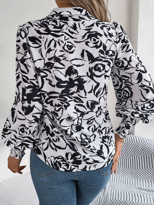 White floral print blouse with shirred cuffs and buttoned front detail.