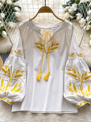 White embroidered tie-neck blouse with yellow wheat detail and tassel ties.